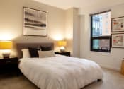 Thumbnail 22 of 28 - a bedroom with a large bed and a window