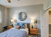 Thumbnail 5 of 37 - A bedroom with a bed, nightstands, and a mirror on the wall. at The Fletcher Southlands, Colorado, 80015