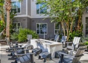 Thumbnail 33 of 69 - an outdoor patio with chairs and a fire pit