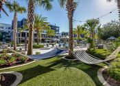 Thumbnail 34 of 69 - a garden with hammocks and palm trees