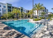Thumbnail 13 of 69 - a swimming pool in front of an apartment building