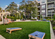 Thumbnail 38 of 69 - an apartment yard with a ping pong table and chairs