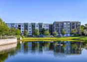 Thumbnail 2 of 69 - a large body of water with a building in the background