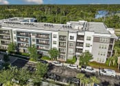 Thumbnail 1 of 69 - an aerial view of a large apartment building with cars parked outside