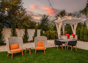 Thumbnail 47 of 69 - a backyard patio with a table and chairs and a pergola