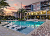 Thumbnail 19 of 69 - a large swimming pool in front of a building