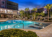 Thumbnail 28 of 69 - a swimming pool at night at the grove apartments