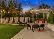 Thumbnail 48 of 69 - a patio with a table and chairs under a canopy