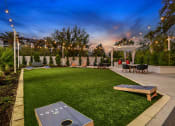 Thumbnail 43 of 69 - a backyard with a grassy lawn and tables and chairs
