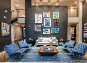 Thumbnail 58 of 69 - Club House Seating Area with Blue Couches and Wall Art