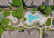 Thumbnail 40 of 43 - A bird's eye view of a residential area with a swimming pool and a fountain.
