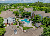 Thumbnail 4 of 43 - A bird's eye view of a residential area with houses and a swimming pool.