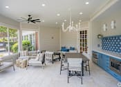 Thumbnail 38 of 43 - A modern kitchen and dining area with a ceiling fan and chandelier.