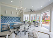 Thumbnail 7 of 43 - A dining room with a table and chairs.