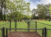 Thumbnail 12 of 25 - A black fence surrounds a baseball diamond.