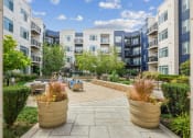 Thumbnail 30 of 51 - an outdoor patio with potted plants at the bradley braddock road station apartments at Indigo 301 Apartments, Pennsylvania, 19406
