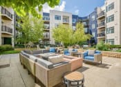 Thumbnail 8 of 51 - an outdoor patio with couches and tables at Indigo 301 Apartments, Pennsylvania, 19406