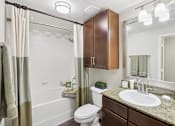 Thumbnail 36 of 39 - A bathroom with a toilet, sink, and shower.