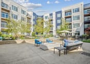 Thumbnail 35 of 51 - an outdoor patio with a firepit and seating area at Indigo 301 Apartments, Pennsylvania, 19406