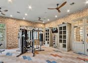 Thumbnail 16 of 39 - A gym with a brick wall and a variety of equipment.