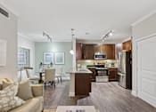 Thumbnail 33 of 39 - A modern kitchen with dark wood cabinets and stainless steel appliances.