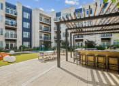 Thumbnail 38 of 51 - an outdoor patio with tables and chairs at Indigo 301 Apartments, Pennsylvania, 19406