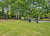 Thumbnail 8 of 20 - A park with a gazebo, benches, and trees.