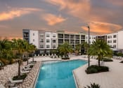 Thumbnail 20 of 69 - Resort Inspired Pool with Palm Trees and Seating