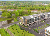 Thumbnail 54 of 65 - an aerial view of an apartment building with a parking lot and a river at Stonehill at West Orange, New Jersey, 07052