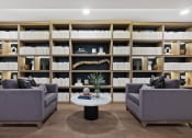 Thumbnail 37 of 65 - a living room with two couches and a table in front of a book shelf at Stonehill at West Orange, West Orange, NJ, 07052