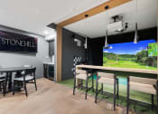 Thumbnail 43 of 65 - a dining room with a bar and a large screen tv at Stonehill at West Orange, West Orange, 07052