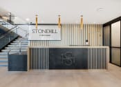 Thumbnail 23 of 65 - the lobby with stairs and a stonhill sign at Stonehill at West Orange, West Orange, 07052