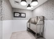 Thumbnail 49 of 65 - a stainless steel bath tub in a bathroom with white tiled walls and a wall at Stonehill at West Orange, West Orange