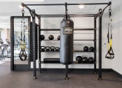 Thumbnail 46 of 65 - a punching bag hanging from a rack in a gym at Stonehill at West Orange, West Orange, New Jersey