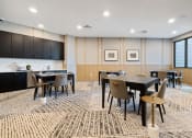 Thumbnail 34 of 65 - a conference room with tables and chairs and a kitchen at Stonehill at West Orange, New Jersey, 07052