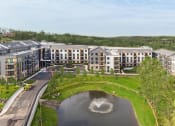 Thumbnail 63 of 65 - an aerial view of a building with a fountain in the middle of a pond at Stonehill at West Orange, West Orange, New Jersey