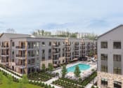 Thumbnail 55 of 65 - an aerial view of an apartment building with a swimming pool at Stonehill at West Orange, West Orange, 07052