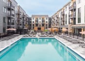 Thumbnail 56 of 65 - a swimming pool in the middle of an apartment building at Stonehill at West Orange, West Orange, New Jersey