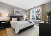 Thumbnail 19 of 65 - a bedroom with a large bed and a large window at Stonehill at West Orange, New Jersey, 07052