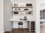 Thumbnail 6 of 65 - a small desk with a chair in a room with shelves at Stonehill at West Orange, West Orange