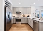 Thumbnail 15 of 65 - a kitchen with stainless steel appliances and white cabinets at Stonehill at West Orange, New Jersey