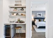 Thumbnail 20 of 65 - a bedroom with a bed and shelves and a stool at Stonehill at West Orange, West Orange, NJ, 07052