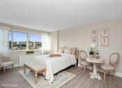 Thumbnail 3 of 14 - a bedroom with a large bed and a large window