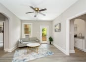 Thumbnail 2 of 15 - a living room with a couch coffee table and a ceiling fan