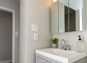 Thumbnail 13 of 14 - a bathroom with a sink and a mirror