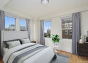 Thumbnail 5 of 17 - a bedroom with a bed and three windows at 1841 Columbia Road Apartments, Washington, DC