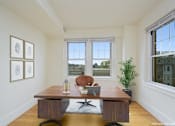 Thumbnail 6 of 17 - a home office with two windows and a wooden desk at 1841 Columbia Road Apartments, Washington, 20009