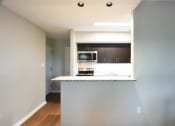 Thumbnail 6 of 27 - a kitchen with a counter top and a stove top oven