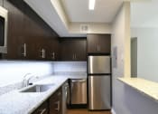 Thumbnail 26 of 27 - a kitchen with granite countertops and stainless steel appliances
