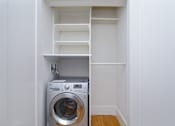 Thumbnail 7 of 17 - a small laundry room with a washer and dryer at 1841 Columbia Road Apartments, Washington, Washington DC